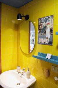 a yellow bathroom with a sink and a mirror at Casa masseria dell'800 Gargano. Le Mignole in Monte SantʼAngelo