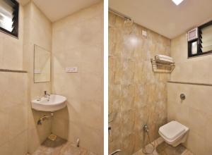 a bathroom with a sink and a toilet at Hotel Royal Rituals Vesu in Surat