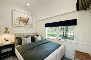 a bedroom with a bed and a window at The Station Hunter Valley in Pokolbin