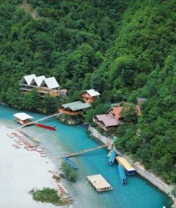 an aerial view of a resort with boats in the water at Guesthouse Zgiboza in Shkodër