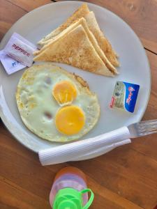 a plate with an egg and two slices of toast at Blue Moon Meno in Gili Meno
