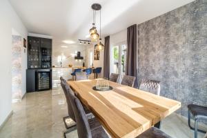 a dining room with a wooden table and chairs at Villa Renesansa in Milna