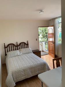 a bedroom with a bed and a door to a patio at Habitación con baño propio para 2 personas como máximo in Lima