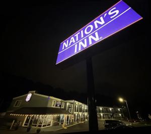 a sign in front of a building at night at NATION'S INN of Wake County - Raleigh Crabtree in Raleigh