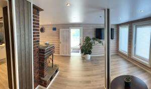 a living room with a brick wall at Jolster sauna apartments in Skei