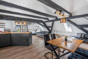 a kitchen and living room with a table and a dining room at #1890 Loft Ansbach in Ansbach