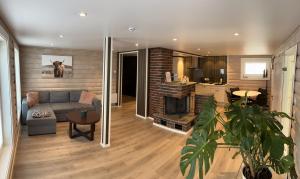 a living room with a couch and a kitchen at Jolster sauna apartments in Skei 