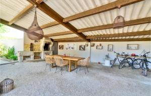 une terrasse avec un plafond en bois, une table et des chaises dans l'établissement Stunning Home In Vallabrgues With Kitchen, à Vallabrègues