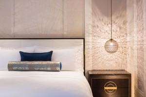 A bed or beds in a room at The St. Regis Langkawi