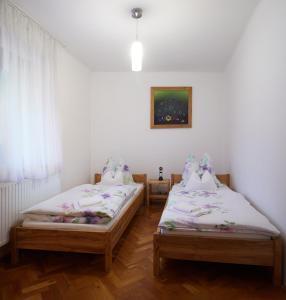 2 camas individuales en una habitación con ventana en KeramikArt-Wohnung, en Pécs