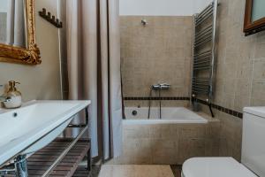 a bathroom with a tub and a sink and a toilet at Elia Seaside Pteleos in Pteleos +33 photos