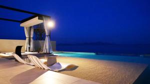 a swimming pool with two chairs and a swimming pool at PLATINUM RESORT in Minami-komatsu