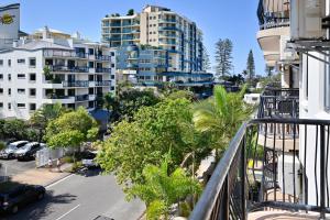 an apartment balcony with a view of a street and buildings at Mooloolaba 2 B/R Getaway - Perfect location ZD5 in Mooloolaba
