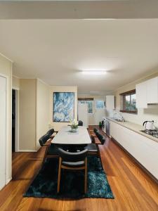 a kitchen and living room with a table and chairs at Fisher River Front in Griffin