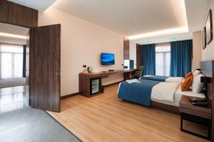 a hotel room with a bed and a desk at WELLNESS HOTEL and SPA in Tashkent