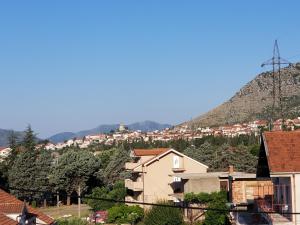 a view of a city with a mountain in the background at Apartmani Vasković in Trebinje
