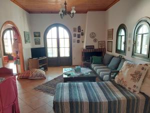 a living room with a couch and a table at PORTO KATSIKI-HOME in Athani