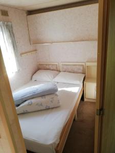 A bed or beds in a room at Kempings Mežmalas