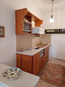 a kitchen with a sink and a stove top oven at PORTO KATSIKI-HOME in Athanion +16 photos