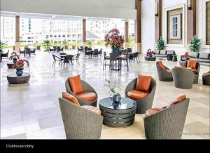a lobby with chairs and tables in a building at Condo Unit at Cool Suites SMDC Wind Tagaytay in Tagaytay