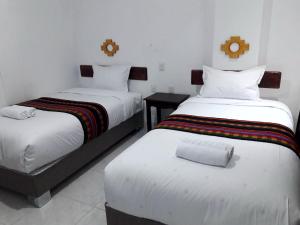 Llit o llits en una habitació de PAKARINA HOTEL