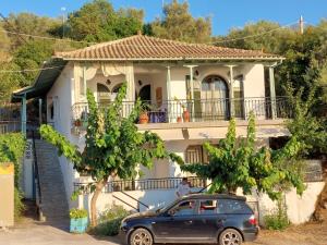 a car parked in front of a house at PORTO KATSIKI-HOME in Athanion