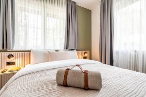 a bedroom with a large white bed with windows at stuub hinterzarten in Hinterzarten