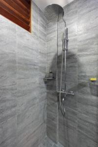 a shower with a glass door in a bathroom at Kalipay Resort Siargao in General Luna