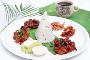 a plate of food on a table with a cup of coffee at The Westin Langkawi Resort & Spa in Kuah