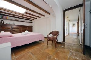 a bedroom with a large bed and a chair at Super Attico con terrazza Lodi in Rome