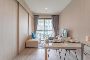 a kitchen and living room with a table and a couch at Aeras beachfront 1 bedroom in Jomtien Beach