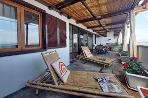 a porch with two chairs and a table with at Super Attico con terrazza Lodi in Rome