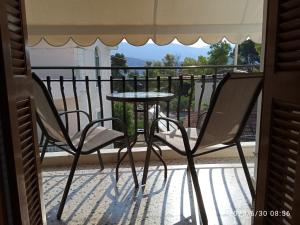 a table and two chairs on a balcony at Dimitra appartements in Argostoli