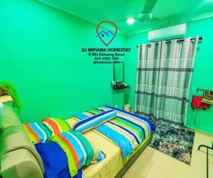 a green bedroom with a bed with colorful pillows at Dj Impiana Homestay @ Bukit Keluang Besut in Kampung Raja