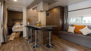 a kitchen with a bar in a tiny house at Polidor Camping Resort in Poreč