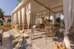 a covered deck with a table and chairs at Polidor Camping Resort in Poreč