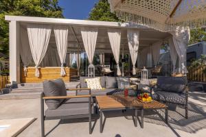 a patio with a couch and chairs and a table at Polidor Camping Resort in Poreč