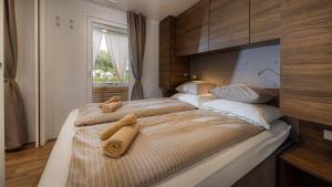 a bedroom with two beds with towels on them at Polidor Camping Resort in Poreč