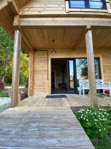 a wooden porch of a house with a table at Labieši in Jūrmala