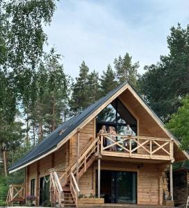 a group of people standing on the balcony of a house at Labieši in Jūrmala
