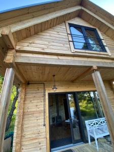 a wooden cabin with a roof with a window at Labieši in Jūrmala