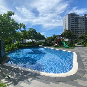 a swimming pool with a slide and a playground at Air Residences 4439 in Manila