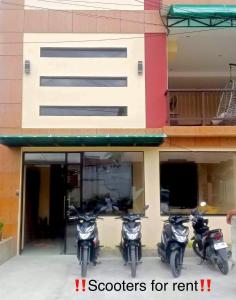 a group of motorcycles parked outside of a building at CASA PRECIOSA MOALBOAL Inn in Moalboal