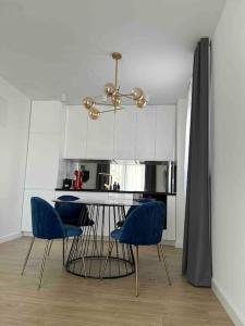 cocina con mesa de comedor y sillas azules en Time&Joy apartment with private pool, en Kaštela