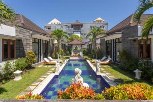an exterior view of a villa with a swimming pool at Designer Studio Emy Sanur in Sanur