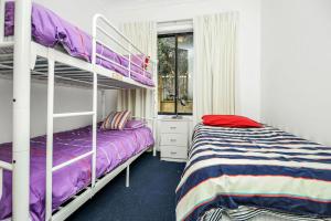 a bedroom with two bunk beds and a window at Beautiful Views Relaxation Awaits You in Encounter Bay