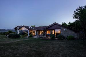 a house with a lot of windows on a yard at Kingsley Lake View in Chew Stoke