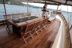 a table and chairs on the back of a boat at Family labuan bajo in Labuan Bajo