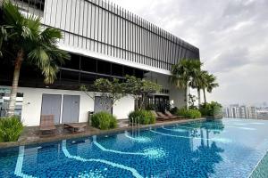 a large swimming pool in front of a building at Super King-Sized Studio-Revo in Kuala Lumpur