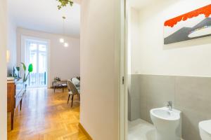 a bathroom with a sink and a toilet in a room at Chiatamone Design Apartment by Wonderful Italy in Naples